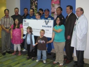 Valero Supervisors, Mark Rodriguez and Matt Wilkins along with other Valero employees join Tres Heald (DSAOC Board President), Dr. Lott (Director, Child Neurology UCI/CHOC) and  children and teens with Down syndrome at CHOC Children’s in Orange.